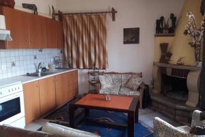 a kitchen with a couch and a table in a room at Efis house in Kalívia