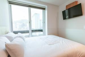 Ein Bett oder Betten in einem Zimmer der Unterkunft Step Inn Myeongdong 1
