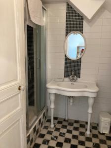 a bathroom with a sink and a mirror at Le Mascaret in Deauville