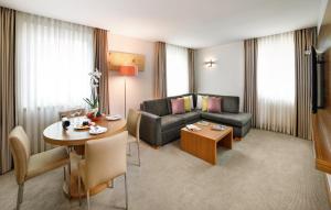 a living room with a couch and a table at Divan Istanbul City in Istanbul