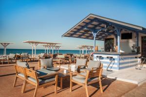 a group of chairs and tables on the beach at AURUM FAMILY RESORT & SPA in Blagoveshchenskaya