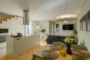 a kitchen and a living room with a dining room table at Casa do Fontanário Stay in Amarante