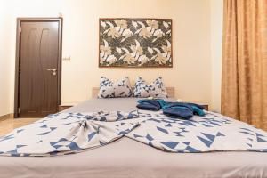 a bed with blue and white sheets and pillows at 1BD apartment in a calm area near the centre in Plovdiv