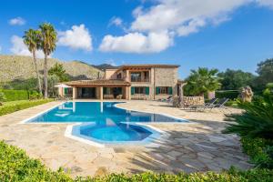a home with a swimming pool and a house at Villa Les Oliveres Antonia By SunVillas Mallorca in El Port