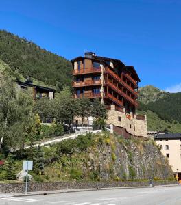 a building on the side of a hill at Luxury Treeline Residence with Hot Tub - By Ski Chalet Andorra in Soldeu