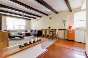 a kitchen and living room with a table and chairs at Krynica Apartamenty 100m Duży Apartament, Salon + 3 sypialnie przy Deptaku in Krynica Zdrój