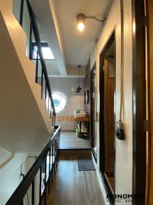 a hallway of a house with a staircase and a room at Monomer Hostel Bangkok in Bangkok