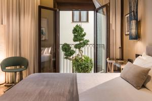 a hotel room with a bed and a balcony at El Llorenc Parc de la Mar - Adults Only (+16) in Palma de Mallorca