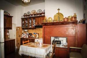 a kitchen with a table and a brick fireplace at Hotel Karpathos in Karpathos Town