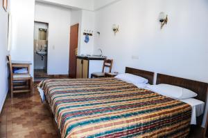 Postel nebo postele na pokoji v ubytování Hotel Karpathos