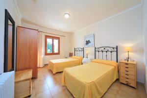 a bedroom with two beds with yellow sheets at Cana Joana in Santa Margalida +22 photos