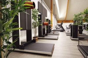 a room filled with lots of plants and machines at Apartment I , Netflix, Küche und Gym in Reken
