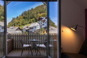 a room with a balcony with a table and chairs at Apartment Muznik in Bled