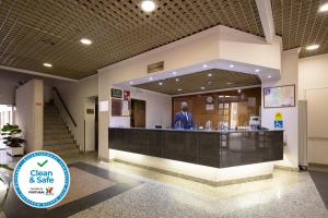 a man standing at a counter in a building at Hotel Anjos in Lisbon