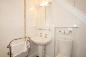 a white bathroom with a sink and a toilet at Fisherman's Cot, Tiverton by Marston's Inns in Tiverton +20 photos