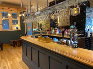 a bar with two faucets on top of it at The Plough in Alnwick