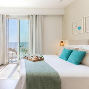 a bedroom with a large bed with a view of the ocean at Albatros Beach Hotel in Letojanni
