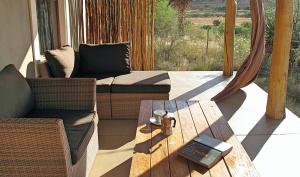 a living room with a couch and a table at River View Cottages in Calitzdorp