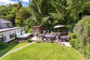 a backyard with a patio with a table and chairs at Deer's Leap Retreat in West Anstey