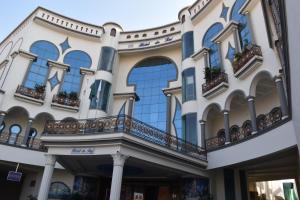 a large building with balconies and windows at Hotel de Raj Sialkot in Sialkot