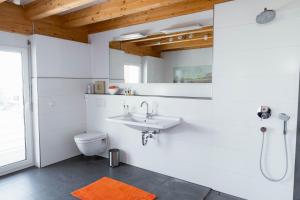 a white bathroom with a sink and a toilet at Businessapart Stuttgart in Gäufelden