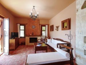 Una sala de estar con un sofá y una chimenea. en Villa Galania Armeni Crete, en Arménoi