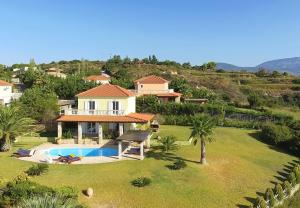 an aerial view of a house with a swimming pool at Villa Dimitra in Trapezaki