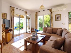 a living room with a couch and a coffee table at Villa Dimitra in Trapezaki