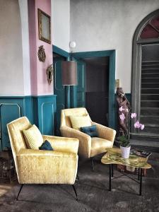 a living room with two chairs and a table at Hotel Casa Camilla in Verbania