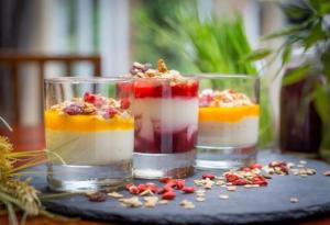 a bowl filled with fruit next to a glass filled with ice cream at Clayton Hotel Birmingham in Birmingham
