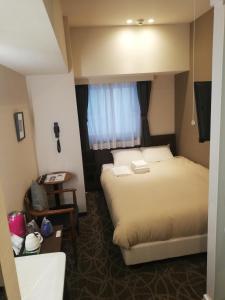 Postel nebo postele na pokoji v ubytování Hotel Emit Ueno