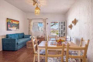 a living room with a table and a blue couch at Casa Adonai in Tuineje