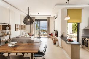 a kitchen and living room with a table and chairs at Villa Anemi in Stérnai