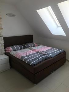 a bed in a room with a skylight at SUNNY VIENNA by JR City Apartments in Vienna