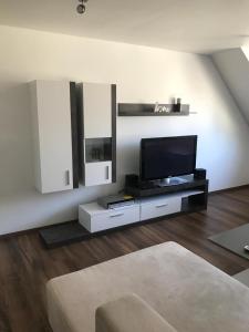 a living room with a flat screen tv on a wall at SUNNY VIENNA by JR City Apartments in Vienna