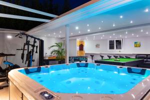 a gym with a pool table and ping pong ball at Villa Green Diamond - Private Heated Pool in Platanes