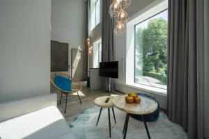 a living room with a couch and a table at HARBR. hotel Konstanz in Konstanz