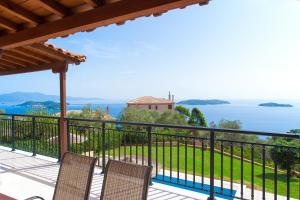 a view of the water from the balcony of a house at Villa Angela in Skiathos