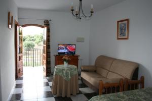 a living room with a couch and a table at El Almendral in El Bosque