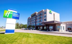 a hotel with a sign in front of a building at Holiday Inn Express - Red Deer North, an IHG Hotel in Red Deer