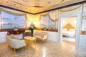 a room with a bed and a table and chairs at Ca' Bonfadini Historic Experience in Venice