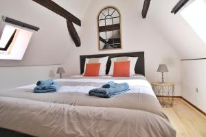 1 dormitorio con 1 cama grande y toallas azules. en LOCBNB - TOURISM and BUSINESS LOCATIONS - ALSACE - BARR CENTRE - ROUTE DES VINS, en Barr