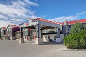 a hotel with a parking lot in front of it at SureStay Plus Hotel by Best Western Drumheller in Drumheller