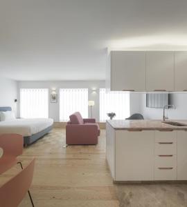 a kitchen and living room with a bed and a counter at Lisbon Serviced Apartments - Principe Real in Lisbon