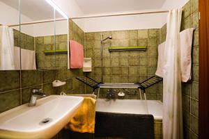 a bathroom with a sink and a bath tub at Ferienwohnung Momo in Braunlage +18 photos