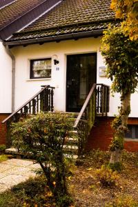 a house with a staircase leading to the front door at Ferienwohnung Momo in Braunlage