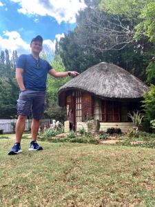a man standing in front of a small hut at Mont Rouge in Clarens