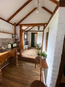 a living room with a large doorway and a table at Cute mini-studio in Blythburgh in Blythburgh