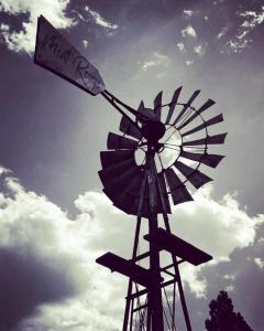 a windmill with a sign that reads north farms at Mont Rouge in Clarens