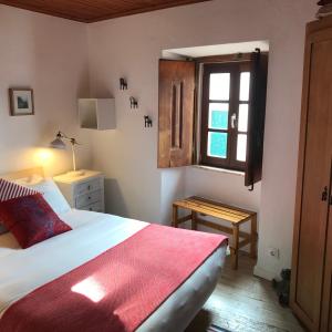 a bedroom with a large bed and a window at The Place at Evoramonte in Évora Monte